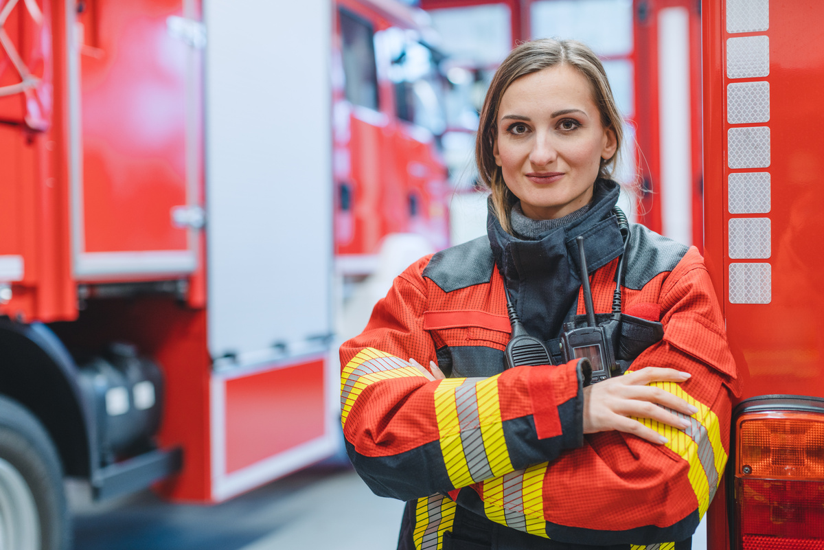 Firefighter Woman Standing in Front of a Fire Truck